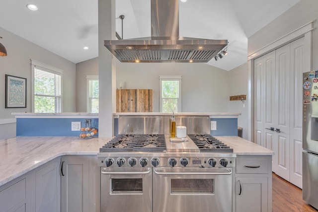6416 Edsel Dr, Nashville, TN 37209 - kitchen featuring vaulted ceiling, stainless steel appliances, island exhaust hood, light stone counters, and wood finished floors