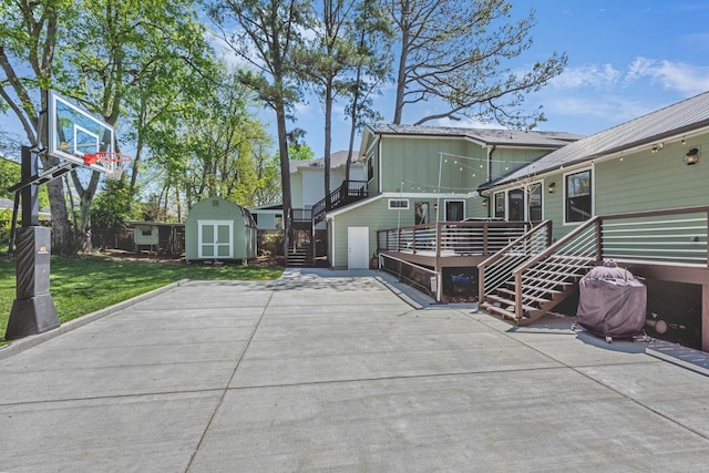 6416 Edsel Dr, Nashville, TN 37209 - view of side of home with a deck, board and batten siding, a lawn, and stairs