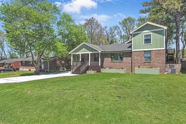 6416 Edsel Dr, Nashville, TN 37209 - view of front of home featuring board and batten siding, brick siding, central AC, and a front lawn