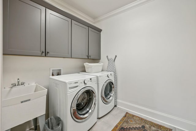 4083 Kings Camp Pass, Arrington, TN 37014 - laundry room with cabinet space, crown molding, washer and dryer, light tile patterned floors, and baseboards