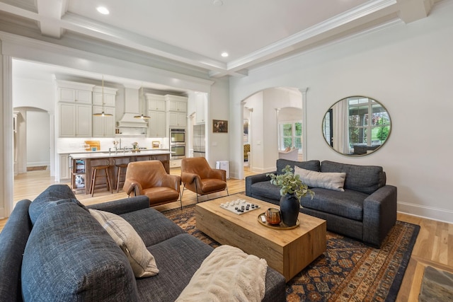 4083 Kings Camp Pass, Arrington, TN 37014 - living area featuring arched walkways, light wood-style floors, ornamental molding, beam ceiling, and recessed lighting