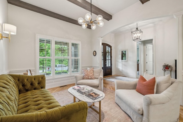 4083 Kings Camp Pass, Arrington, TN 37014 - living area with arched walkways, a chandelier, beamed ceiling, and french doors