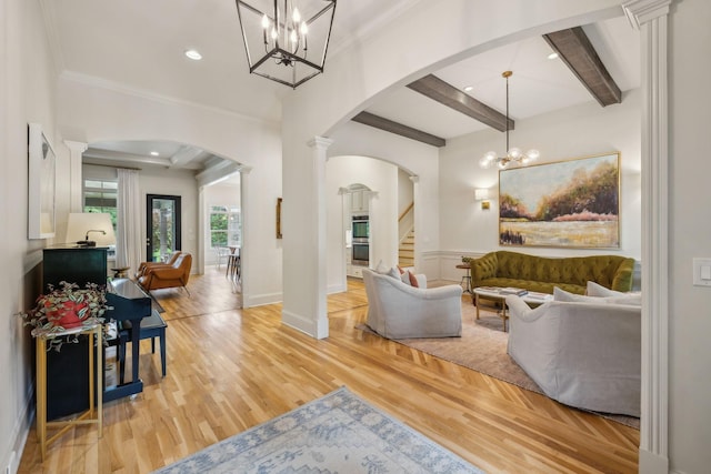 4083 Kings Camp Pass, Arrington, TN 37014 - living area featuring decorative columns, arched walkways, light wood-style flooring, a chandelier, and stairway