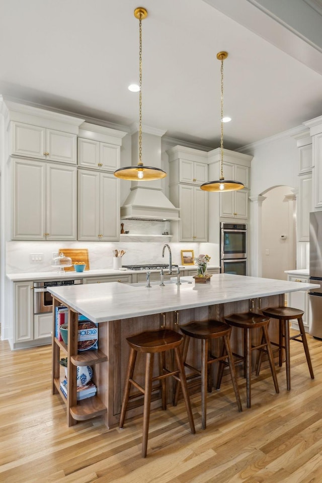 4083 Kings Camp Pass, Arrington, TN 37014 - kitchen with open shelves, appliances with stainless steel finishes, a sink, arched walkways, and ornamental molding