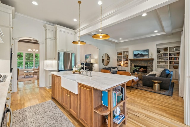 4083 Kings Camp Pass, Arrington, TN 37014 - kitchen with arched walkways, freestanding refrigerator, open shelves, a sink, and crown molding