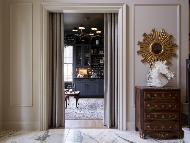 4516 Shys Hill Rd, Nashville, TN 37215 - wine cellar featuring a chandelier, light marble finish flooring, baseboards, and a sink