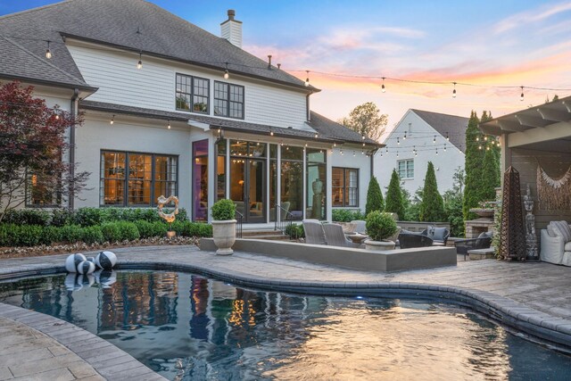 4516 Shys Hill Rd, Nashville, TN 37215 - swimming pool with a sunroom, an outdoor kitchen, and a patio area