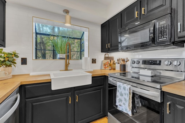 235 Glenstone Cir, Brentwood, TN 37027 - kitchen with appliances with stainless steel finishes, butcher block countertops, tasteful backsplash, and a sink