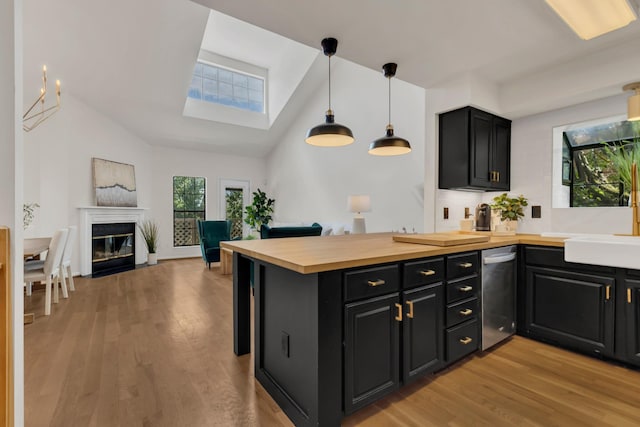 235 Glenstone Cir, Brentwood, TN 37027 - kitchen featuring dishwasher, a skylight, dark cabinetry, light wood finished floors, and high vaulted ceiling