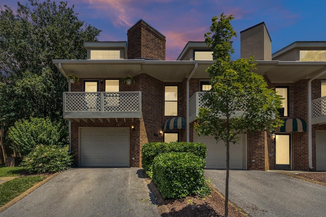 235 Glenstone Cir, Brentwood, TN 37027 - townhome / multi-family property featuring asphalt driveway, brick siding, an attached garage, and a chimney