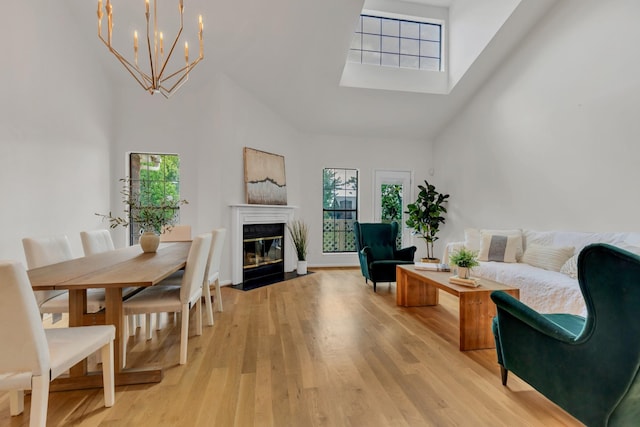 235 Glenstone Cir, Brentwood, TN 37027 - living area featuring a high ceiling, light wood-style floors, a fireplace with flush hearth, a skylight, and a chandelier