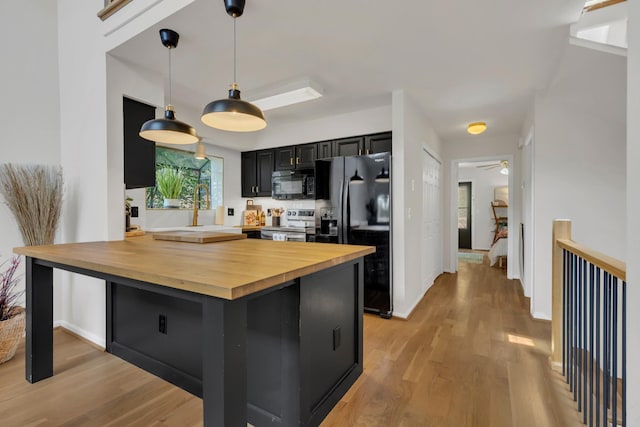 235 Glenstone Cir, Brentwood, TN 37027 - kitchen featuring black appliances, wood counters, dark cabinetry, and light wood finished floors