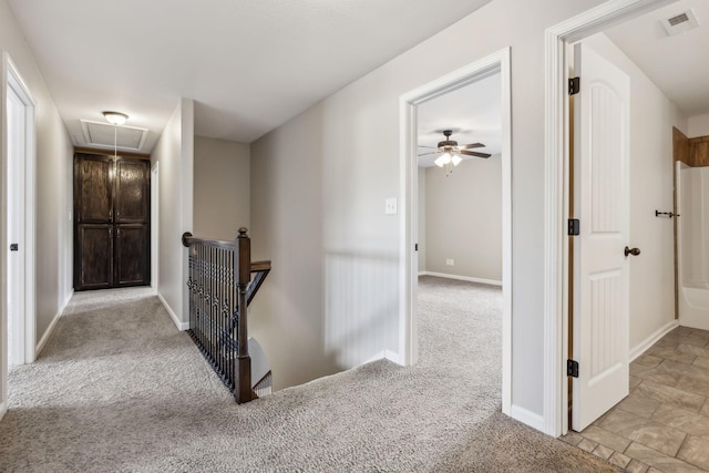 3296 Wiser Dr, Clarksville, TN 37042 - hallway featuring attic access, an upstairs landing, carpet floors, and stone finish flooring