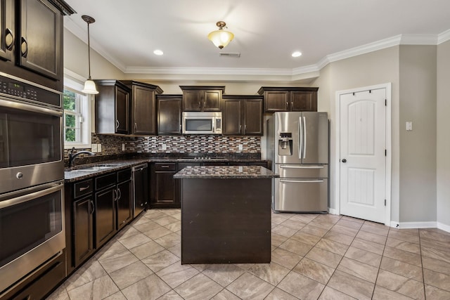 3296 Wiser Dr, Clarksville, TN 37042 - kitchen featuring appliances with stainless steel finishes, dark stone counters, backsplash, dark brown cabinetry, and a center island