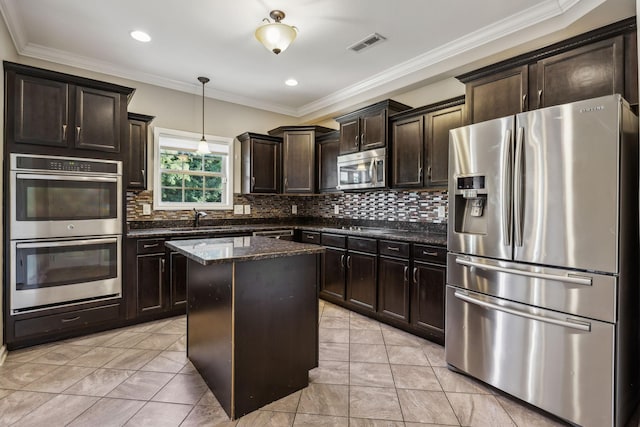 3296 Wiser Dr, Clarksville, TN 37042 - kitchen with stainless steel appliances, dark stone countertops, dark brown cabinets, decorative backsplash, and ornamental molding