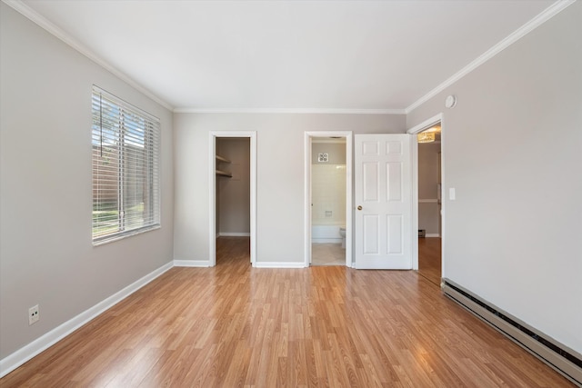 3600 Hillsboro Pike Unit A1, Nashville, TN 37215 - unfurnished bedroom featuring baseboard heating, a spacious closet, crown molding, light wood finished floors, and baseboards