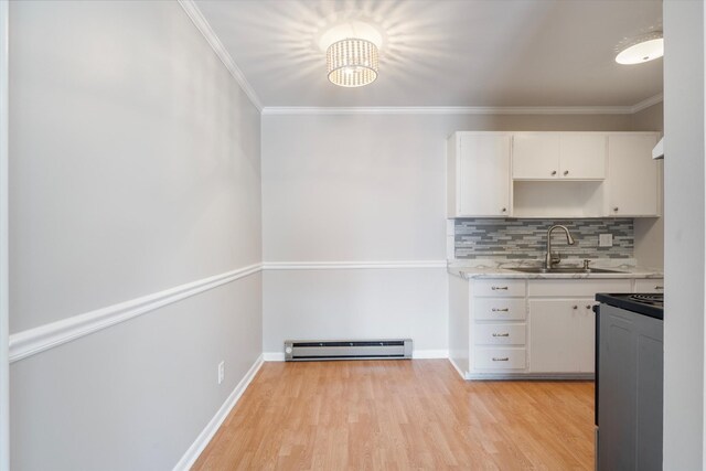 3600 Hillsboro Pike Unit A1, Nashville, TN 37215 - kitchen featuring a baseboard radiator, a sink, range, white cabinetry, and light countertops