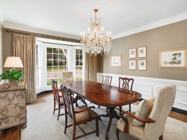 504 Chippenham Ct, Franklin, TN 37069 - dining area featuring crown molding, a chandelier, wood finished floors, and a wainscoted wall