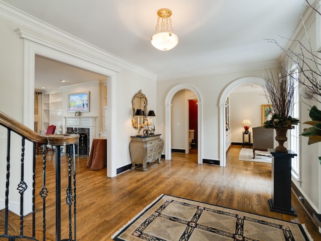 504 Chippenham Ct, Franklin, TN 37069 - entryway with arched walkways, crown molding, a premium fireplace, wood finished floors, and baseboards