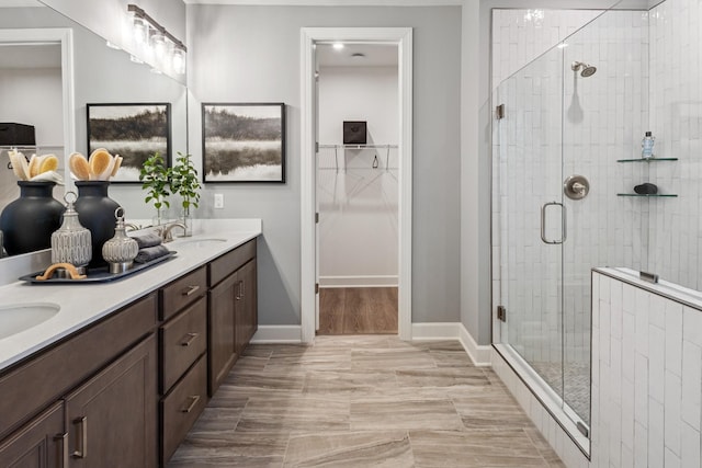 800 Cawthorn Ln, Mount Juliet, TN 37122 - bathroom featuring double vanity, a stall shower, a spacious closet, and baseboards