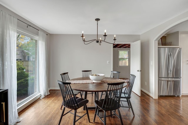 418 Boyd Mill Ave, Franklin, TN 37064 - dining area with wood finished floors, a chandelier, arched walkways, and baseboards