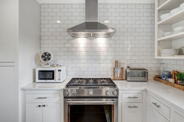 418 Boyd Mill Ave, Franklin, TN 37064 - kitchen with stainless steel range with gas cooktop, white microwave, wall chimney range hood, backsplash, and open shelves