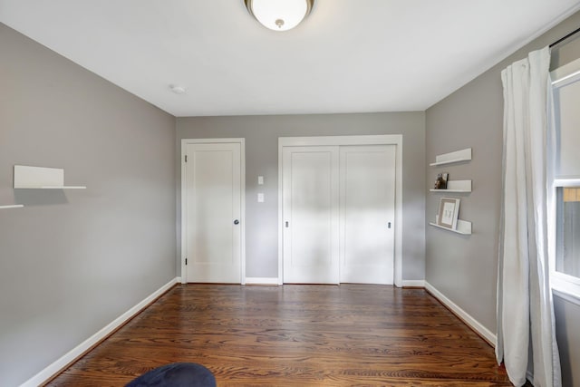 418 Boyd Mill Ave, Franklin, TN 37064 - unfurnished bedroom featuring wood finished floors, baseboards, and a closet