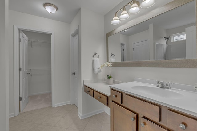 1039 Hemlock Dr, Spring Hill, TN 37174 - full bath with vanity, a walk in closet, tile patterned flooring, tiled shower, and baseboards
