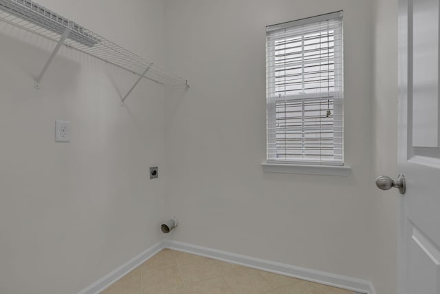 1039 Hemlock Dr, Spring Hill, TN 37174 - laundry room with hookup for an electric dryer, baseboards, plenty of natural light, and light tile patterned floors