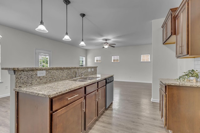 1039 Hemlock Dr, Spring Hill, TN 37174 - kitchen with a sink, stainless steel dishwasher, a ceiling fan, baseboards, and light stone countertops