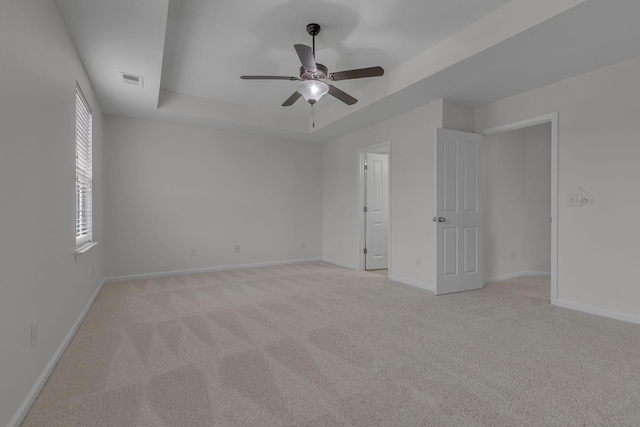 1039 Hemlock Dr, Spring Hill, TN 37174 - unfurnished bedroom with a tray ceiling, light colored carpet, baseboards, and ceiling fan