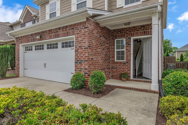 1039 Hemlock Dr, Spring Hill, TN 37174 - entrance to property with brick siding, a garage, and cooling unit