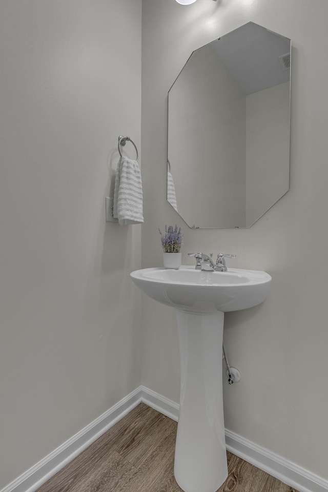 1039 Hemlock Dr, Spring Hill, TN 37174 - bathroom with wood finished floors, baseboards, and a sink