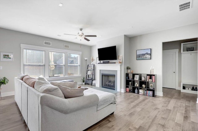 8792 Snowy Owl Rd, Ooltewah, TN 37363 - living area featuring ceiling fan, a fireplace, and wood finished floors