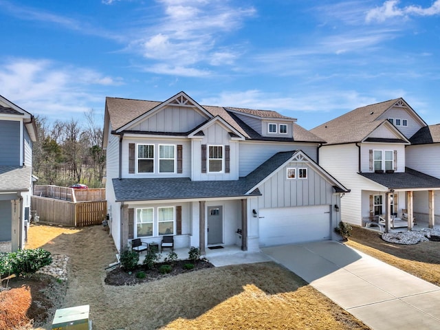 8792 Snowy Owl Rd, Ooltewah, TN 37363 - view of front facade featuring board and batten siding, covered porch, driveway, and roof with shingles