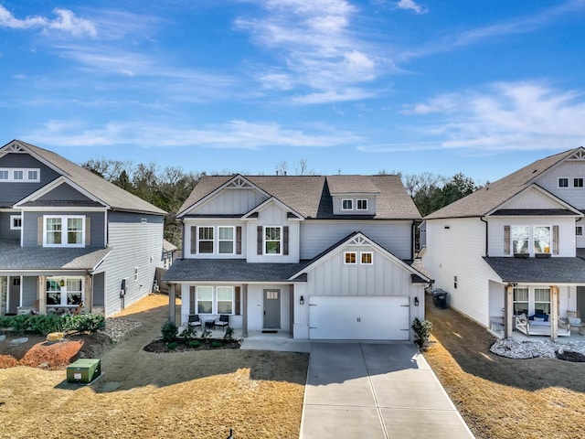 8792 Snowy Owl Rd, Ooltewah, TN 37363 - view of front of house featuring board and batten siding, a porch, concrete driveway, a shingled roof, and an attached garage