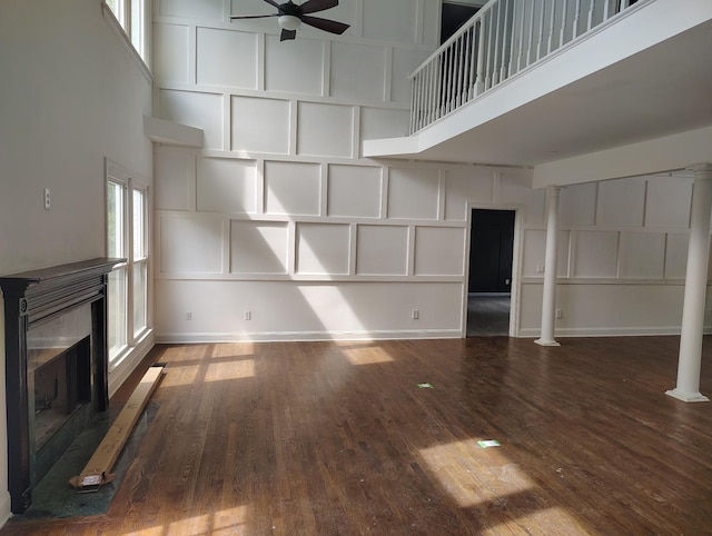 1202 Willow Brook Pass, Mount Juliet, TN 37122 - unfurnished living room featuring a towering ceiling, a fireplace, a ceiling fan, a decorative wall, and wood finished floors