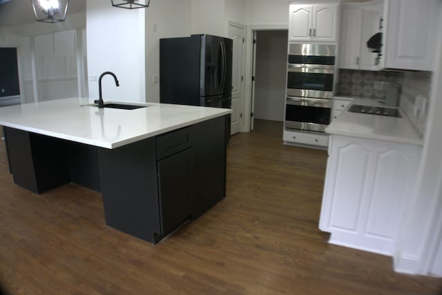 1202 Willow Brook Pass, Mount Juliet, TN 37122 - kitchen with a sink, black appliances, dark wood-style floors, white cabinets, and light countertops
