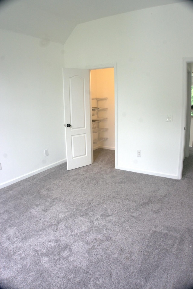 1202 Willow Brook Pass, Mount Juliet, TN 37122 - unfurnished bedroom featuring carpet flooring, a walk in closet, lofted ceiling, and baseboards