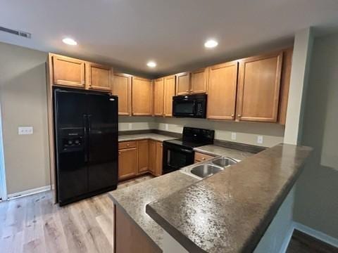 312 Mapleton Aly, Hermitage, TN 37076 - kitchen featuring black appliances, a sink, a peninsula, light wood-type flooring, and recessed lighting