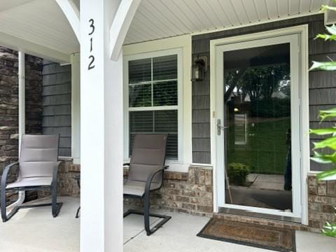 312 Mapleton Aly, Hermitage, TN 37076 - view of exterior entry with stone siding and a porch