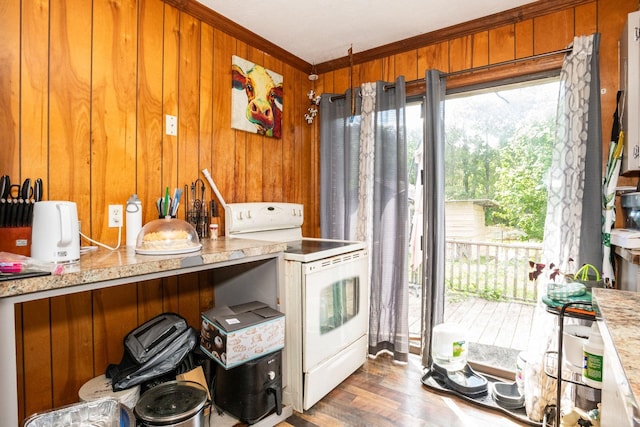 135 Old Union Church Rd, Holladay, TN 38341 - kitchen featuring white range with electric cooktop, ornamental molding, healthy amount of natural light, wooden walls, and brown cabinetry