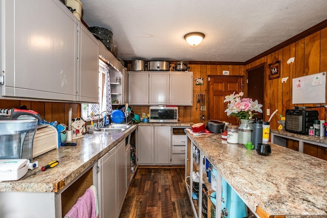 135 Old Union Church Rd, Holladay, TN 38341 - kitchen with a sink, light countertops, wood walls, dark wood-style floors, and stainless steel microwave
