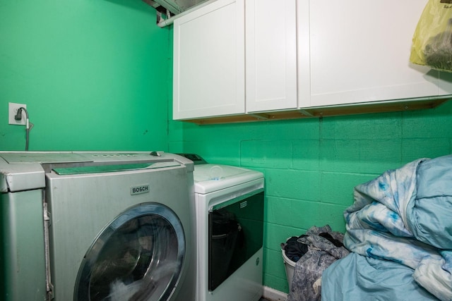 135 Old Union Church Rd, Holladay, TN 38341 - washroom with separate washer and dryer, cabinet space, and concrete block wall