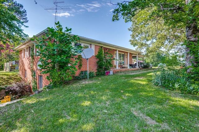 135 Old Union Church Rd, Holladay, TN 38341 - view of front of home featuring a front yard, brick siding, and covered porch