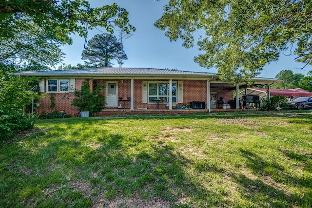 135 Old Union Church Rd, Holladay, TN 38341 - ranch-style home featuring brick siding, a front lawn, metal roof, and a carport