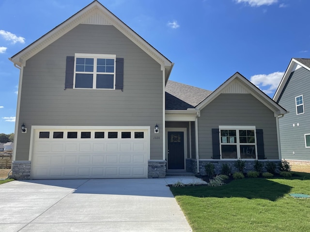 1020 Wiseman Farm Rd, Fairview, TN 37062 - craftsman inspired home with stone siding, concrete driveway, a front yard, an attached garage, and a shingled roof