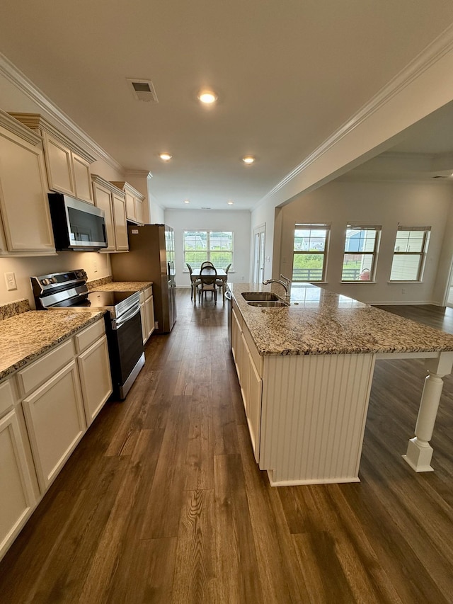 1020 Wiseman Farm Rd, Fairview, TN 37062 - kitchen featuring stainless steel appliances, dark wood-style floors, an island with sink, light stone counters, and recessed lighting
