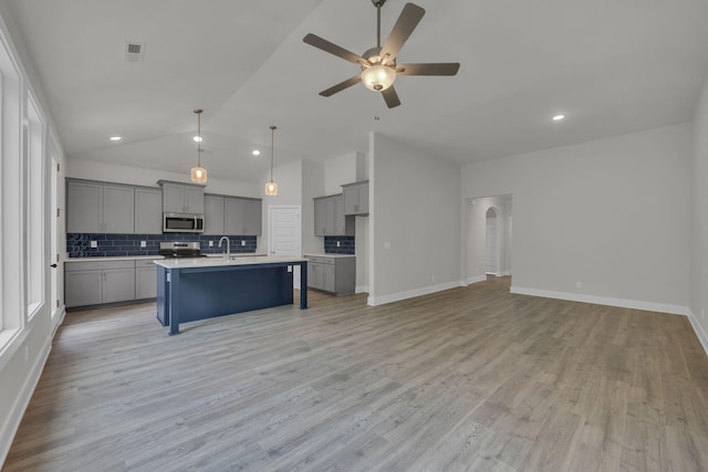 8545 Ari Ln, Chattanooga, TN 37421 - kitchen featuring stainless steel appliances, gray cabinetry, open floor plan, decorative backsplash, and a ceiling fan