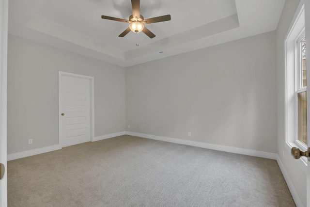 8545 Ari Ln, Chattanooga, TN 37421 - unfurnished room featuring a tray ceiling, carpet, a ceiling fan, and baseboards